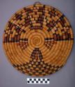 Bundle coiled basket plaque (po:ta). Design of abstract kachina.