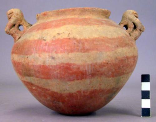 Pottery jar, handles, plastic work and rudely carved to represent human form