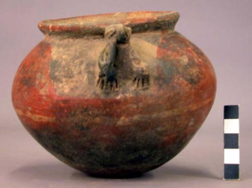 Pottery jar, handles, plastic work and rudely carved to represent human form