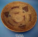 Large basket tray. Coil technique. Made of bear grass. Geometric designs in b