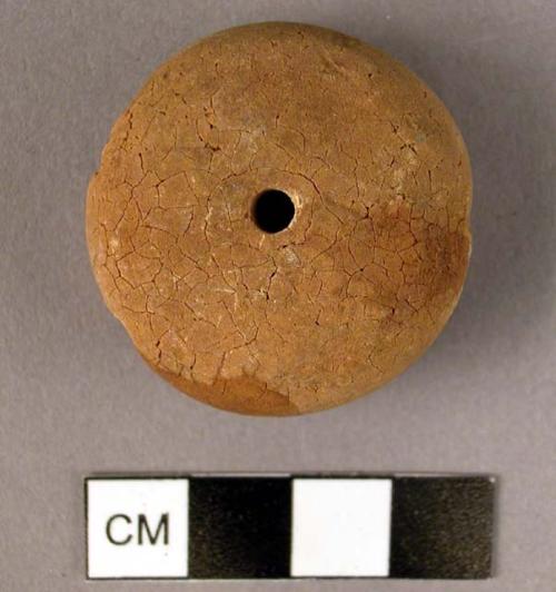 Disk-shaped amber pendant, cross-drilled