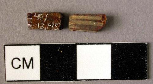 Rectangular amber spacer, decorated on one side with two grooves