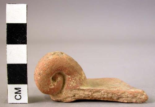 Potsherd - red glaze with curled feet