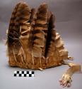 Man's headdress of buckskin. Open at back. Edges pinked and 2 fringes on top.