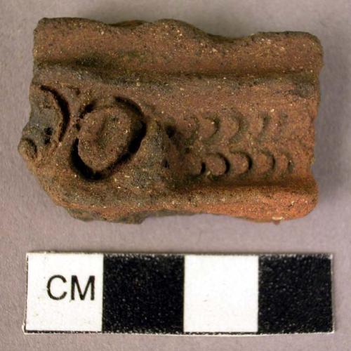 Red ware sherd - 2 ridges with involved rolled or stamped pattern between