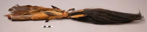 Arapaho dance wand of bison tail, eagle feather, and beaded wood handle.