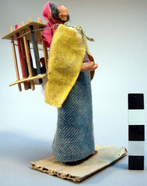 Wax figure of woman with cage of hens - "vendedora de gallinas"