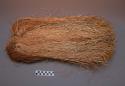 Arm ornament of shredded palm fiber