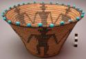 Basket, coiled. Black designs of human figures; blue glass beads around rim.