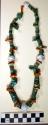Navajo turquoise and shell necklace w/ 4 tubular coral beads at neck. Most of th