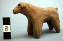 Unfired clay figurine depicting dog