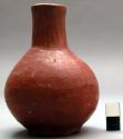 Narrow necked jar. red burnished ceramic.
