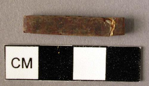 Rectangular amber spacer, decorated on one side with two grooves