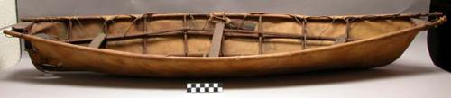 Model of "umiak," wooden frame with skin covering, two wooden paddles