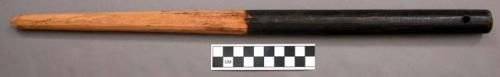 Tapered pointed stick, carved wood, perforated/painted black at thicker end