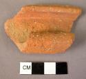 Rim fragment of pottery (very recurved) and fragment of raised horizontal band