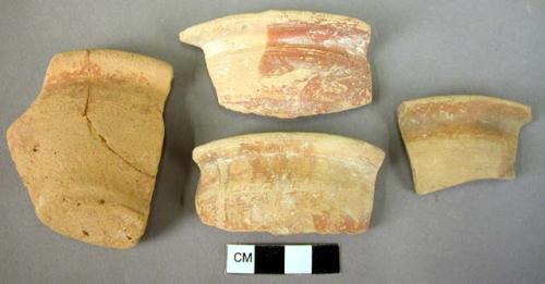 Flat splayed pottery cup fragments with everted rims.