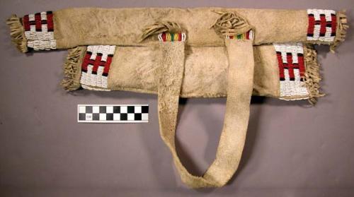 Boy's quiver case. Made of leather and fringed. Multi-colored beadwork.