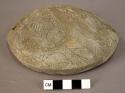 Ceramic lid, plain, incised design, 2 perforations, mended, reconstructed