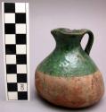 Small pitcher. ceramic, upper half is green glazed.