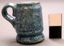 Miniature handled mug, blue glazed ceramic