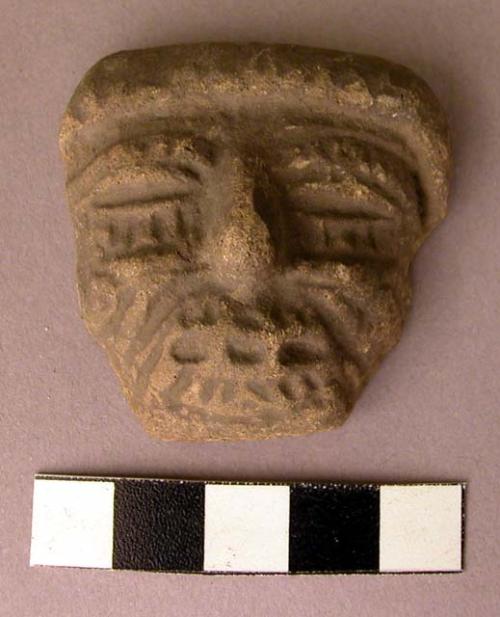 Clay figurine fragment - face