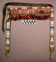 Bridle decoration. Made of rawhide. Ornamented with multi-colored beadwork.