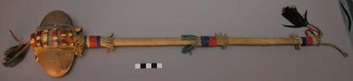 War club--skin covered wooden handle decorated with fringe and beadwork
