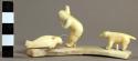 Ivory carving on bone platform - man hunting seal.