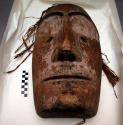 Carved and painted wooden mask, originally had mustache and beard *