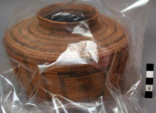 Jar-shaped basket, coiled. Geometric designs.