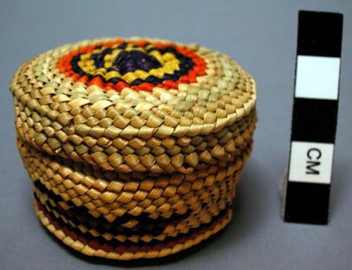 Miniature wrapped twined grass basket (A) with lid (B); whale motif