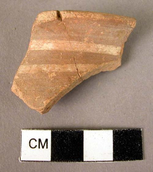 Rim potsherd - white on red slip