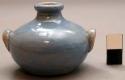 Miniature handled pouring  jar, one on either side, blue glazed ceramic
