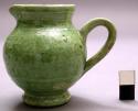 Miniature pitcher, green glazed ceramic
