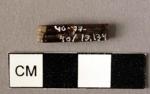 Rectangular amber spacer, decorated on one side with two grooves