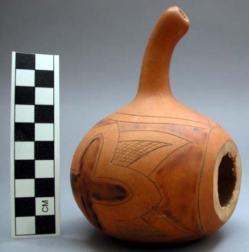 Gourd with burnished and incised decoration- floral forms. Hole cut into side.