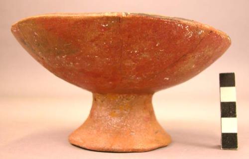 Restored black-on-red pottery pedestal vessel