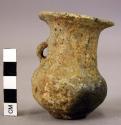 Small pottery high necked jar with outcurving lip and one handle