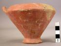 Red glazed, dull pottery vessel