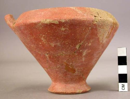 Red glazed, dull pottery vessel