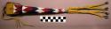 Beaded awl or scissors case--long and conical. Made of rawhide.