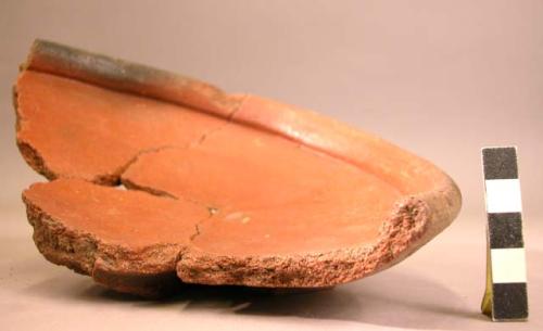 Restored sherd of shallow red pottery vessel