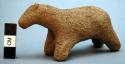 Unfired clay figurine depicting goat