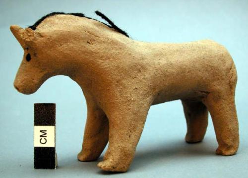 Unfired clay figurine depicting horse