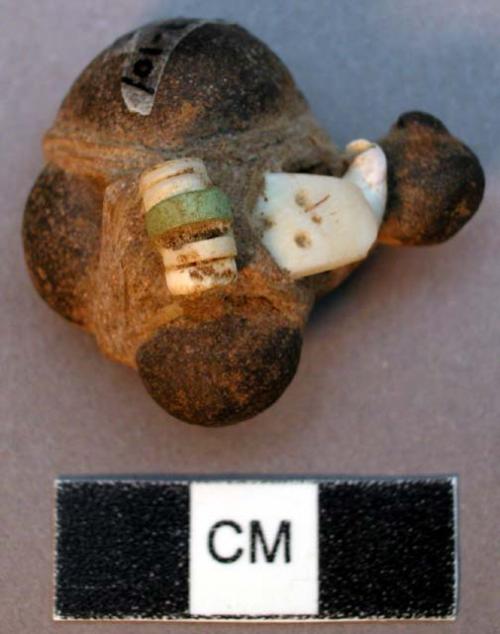 Zuni stone fetish, possibly in shape of turtle. Bundle of bone, shell, shell bea