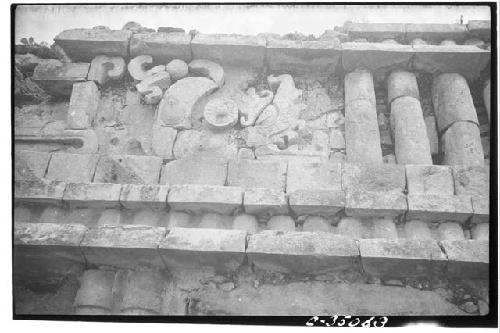 Mask-panel serpent motif. Right center figure. Palace. Str. 2BI.