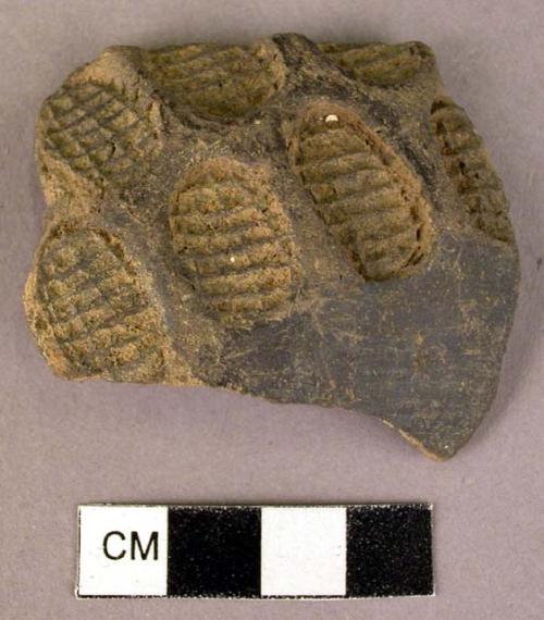 Black ware sherd - deeply stamped with small ovoid corn husk pattern