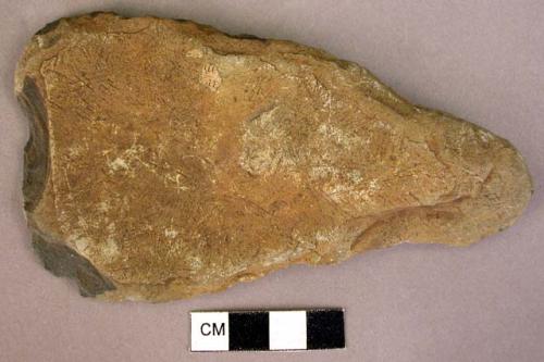 Indurated shale axe; retouched, in later times used as scraper or knife +