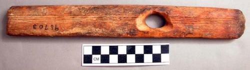 Long, rectangular with perforation near center. Catalog: “wrench made from thro